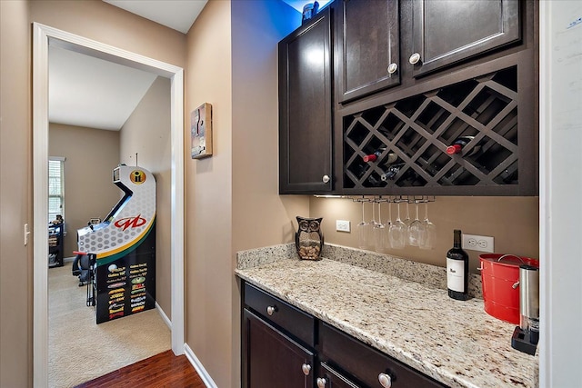 5633 Golf Pointe Dr, Clarkston, MI 48348 - indoor dry bar featuring baseboards and dark wood finished floors
