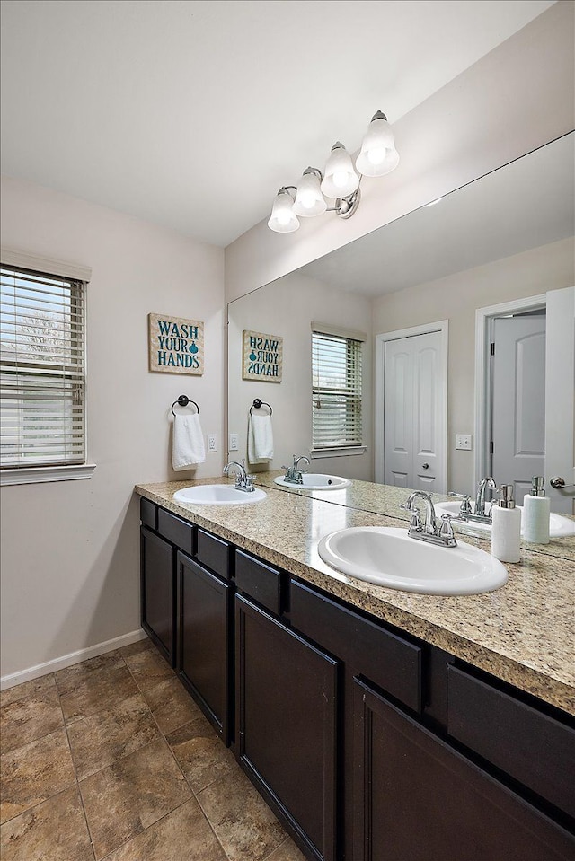 5633 Golf Pointe Dr, Clarkston, MI 48348 - bathroom featuring double vanity and baseboards