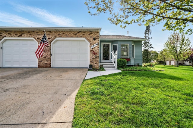 view of front of property with concrete driveway, a front yard, an attached garage, brick siding, and entry steps