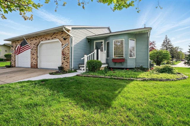 view of front of home featuring a garage, a front lawn, concrete driveway, and brick siding