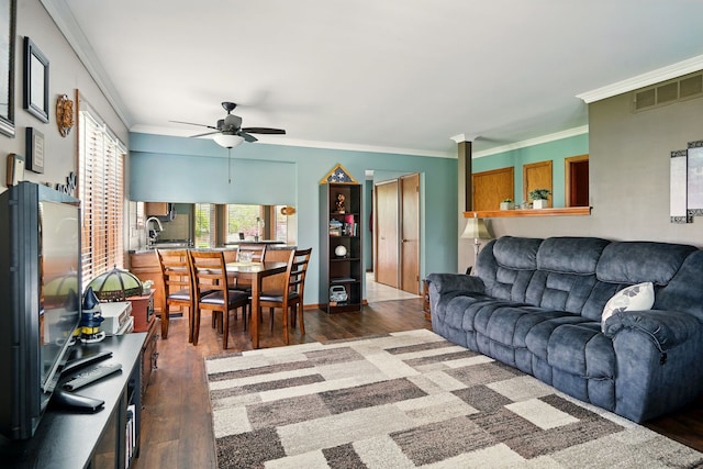 living room featuring ceiling fan, wood finished floors, and ornamental molding