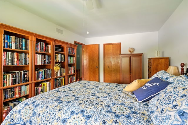 bedroom featuring two closets and ceiling fan