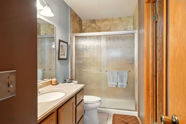 full bathroom with tile patterned floors, a shower stall, toilet, and vanity