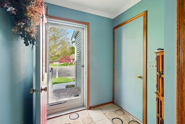 foyer entrance with ornamental molding and tile patterned floors