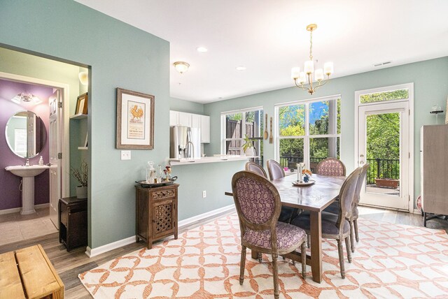 dining room featuring baseboards, a chandelier, plenty of natural light, and recessed lighting