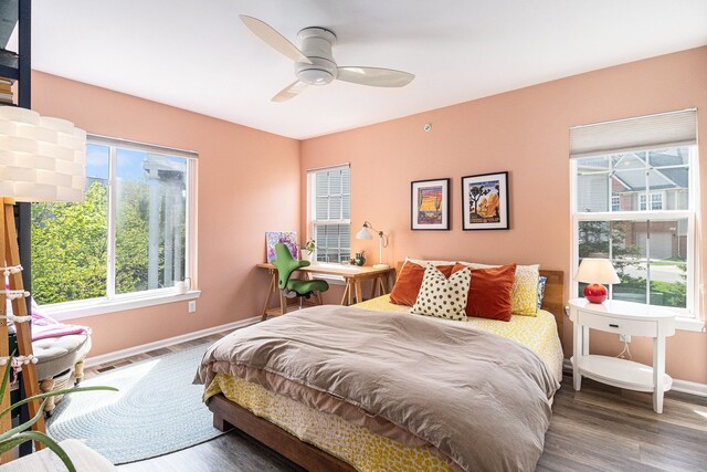 bedroom with baseboards, wood finished floors, and a ceiling fan