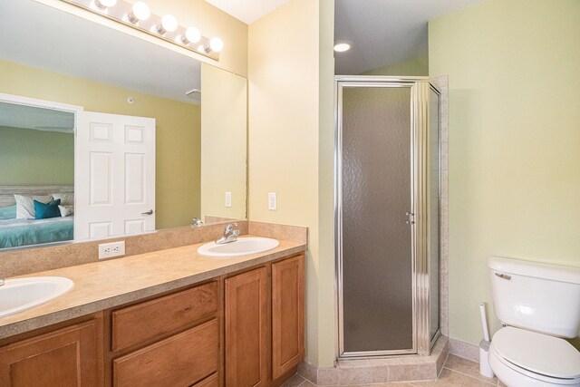 full bathroom with toilet, a stall shower, tile patterned flooring, ensuite bathroom, and double vanity