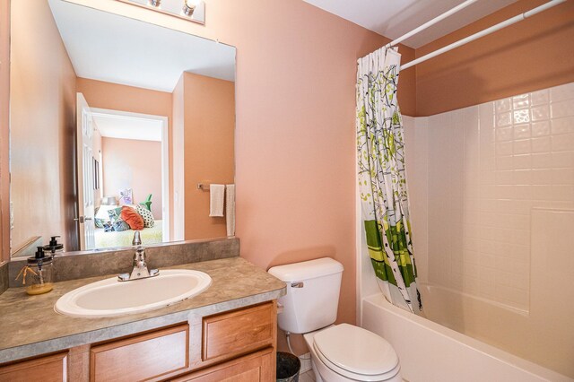 full bath with toilet, vanity, and shower / tub combo