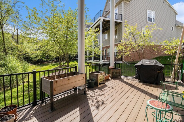 wooden terrace featuring a grill