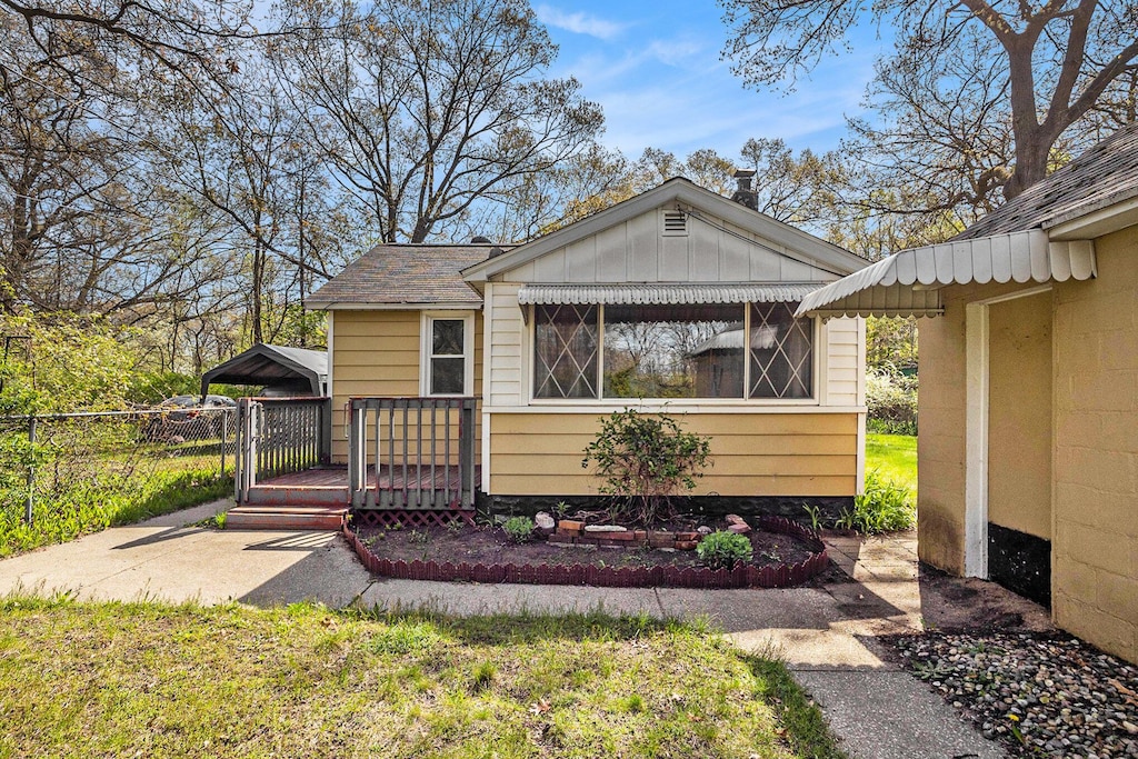 view of front of property with fence, board and batten siding, and a wooden deck