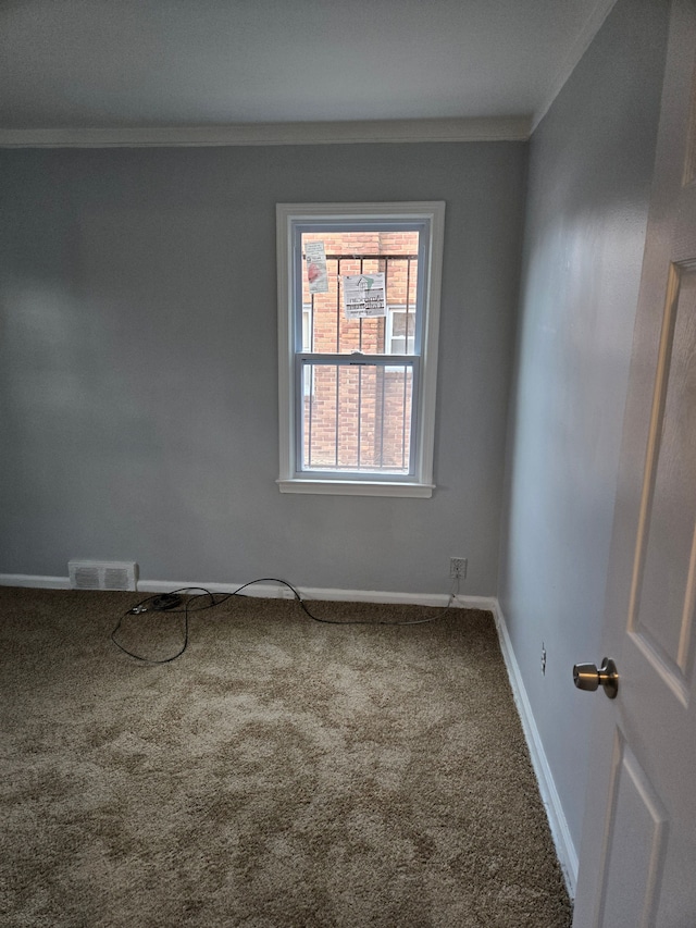 carpeted spare room with ornamental molding and baseboards