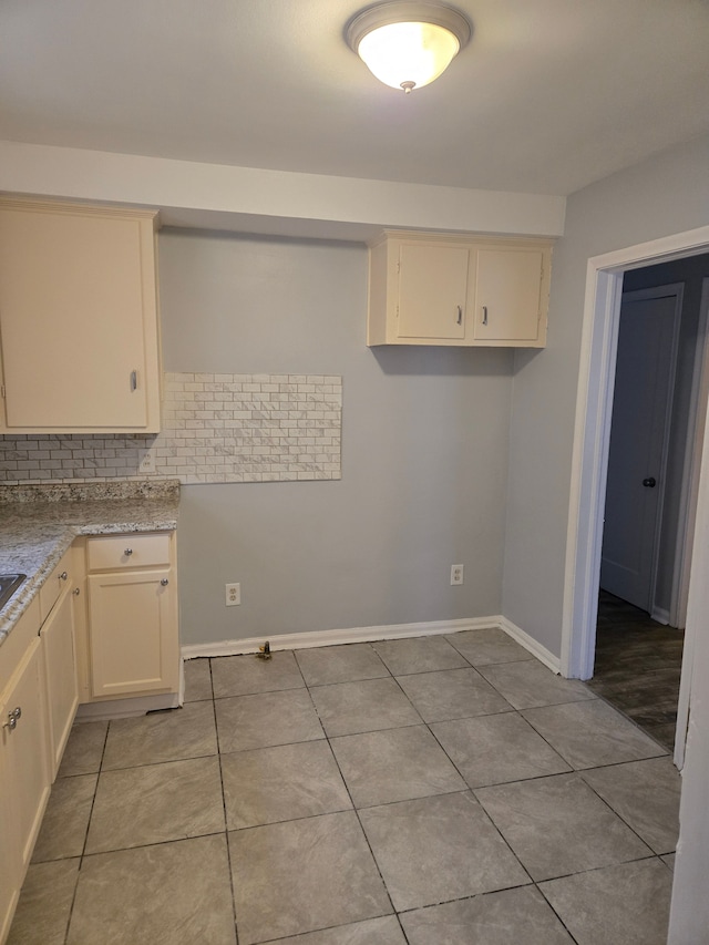 kitchen with cream cabinets and light tile patterned floors