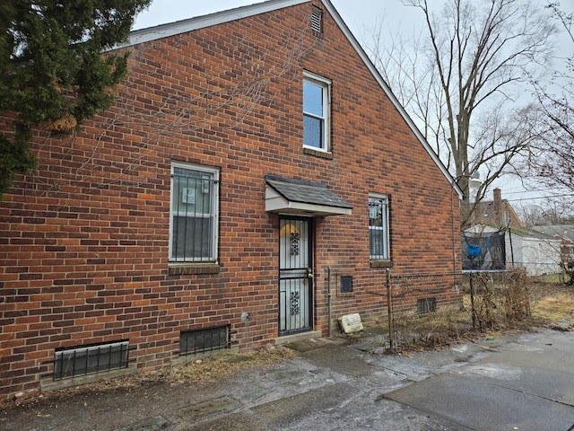 view of front of house with brick siding and a trampoline