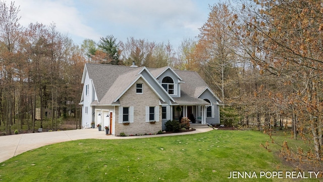 16840 Cricket Ct, Grand Haven, MI 49417 - view of front of property featuring brick siding, concrete driveway, a front lawn, a garage, and a shingled roof