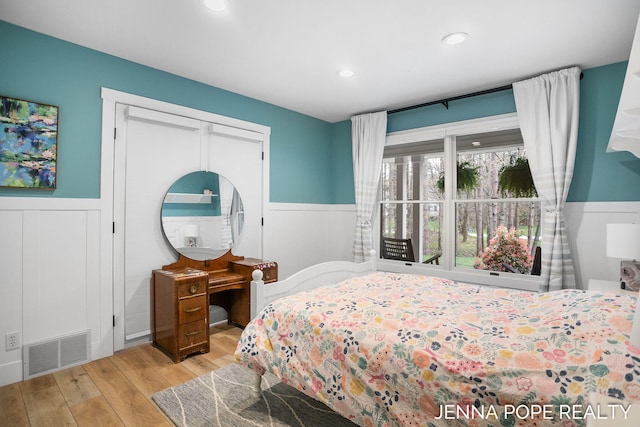 16840 Cricket Ct, Grand Haven, MI 49417 - bedroom featuring a wainscoted wall, wood finished floors, and recessed lighting