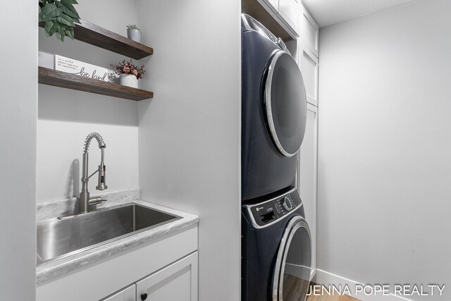 16840 Cricket Ct, Grand Haven, MI 49417 - washroom featuring stacked washing machine and dryer and cabinet space