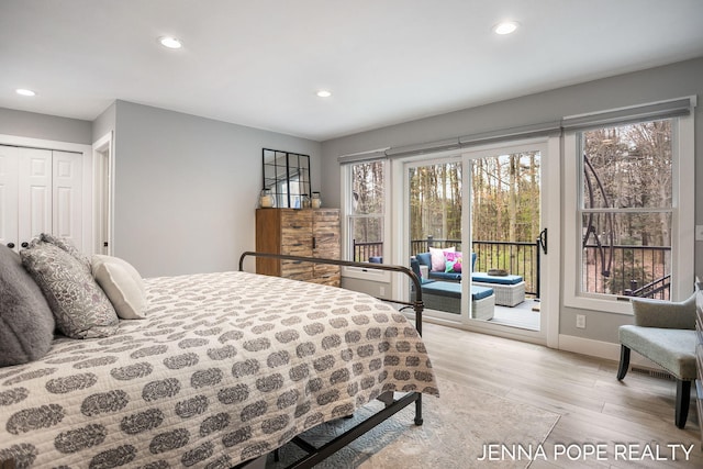 16840 Cricket Ct, Grand Haven, MI 49417 - bedroom with access to exterior, recessed lighting, light wood-type flooring, multiple windows, and baseboards