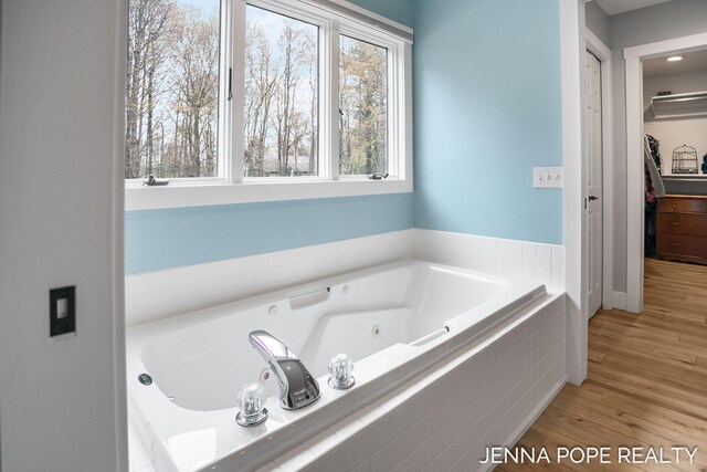 16840 Cricket Ct, Grand Haven, MI 49417 - bathroom featuring wood finished floors and a whirlpool tub