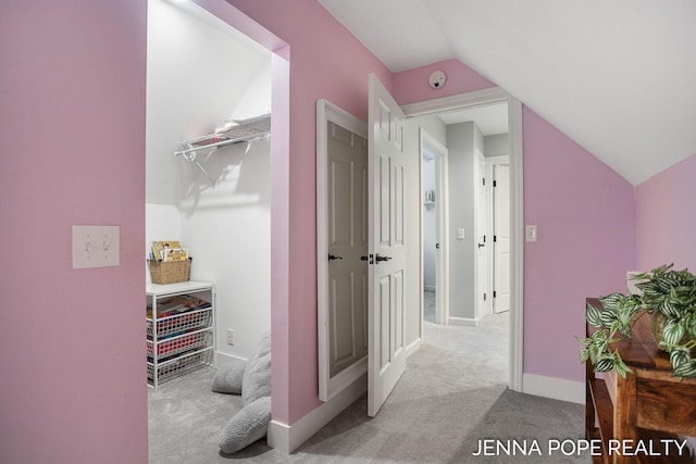 16840 Cricket Ct, Grand Haven, MI 49417 - hallway with vaulted ceiling, carpet, and baseboards