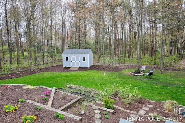 16840 Cricket Ct, Grand Haven, MI 49417 - view of grassy yard featuring a vegetable garden, a storage shed, and an outbuilding