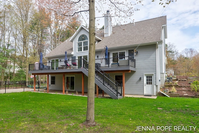 16840 Cricket Ct, Grand Haven, MI 49417 - back of property with a deck, stairway, a chimney, and a shingled roof