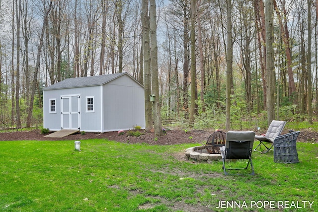 16840 Cricket Ct, Grand Haven, MI 49417 - view of green lawn featuring a fire pit, a shed, and an outdoor structure