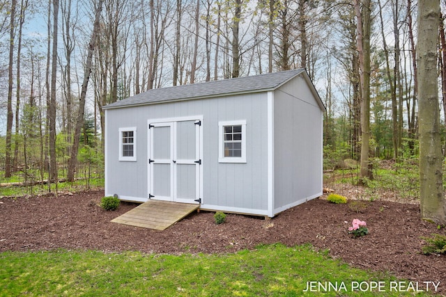 16840 Cricket Ct, Grand Haven, MI 49417 - view of shed featuring view of wooded area