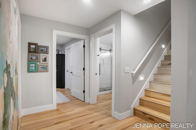 16840 Cricket Ct, Grand Haven, MI 49417 - stairs with baseboards and wood finished floors