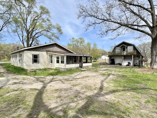 back of property with a sunroom