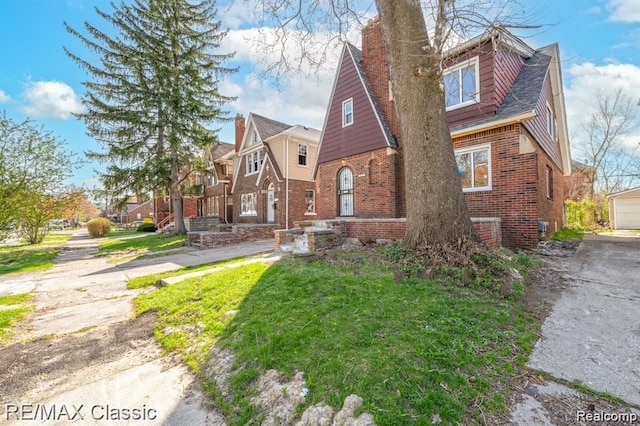 view of front facade featuring brick siding and a residential view