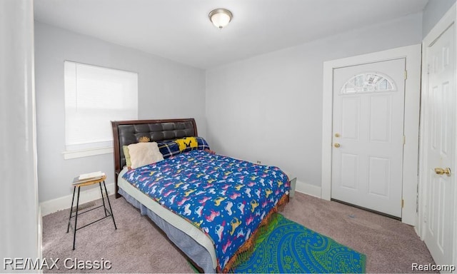 bedroom with carpet and baseboards