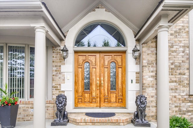 view of exterior entry with brick siding