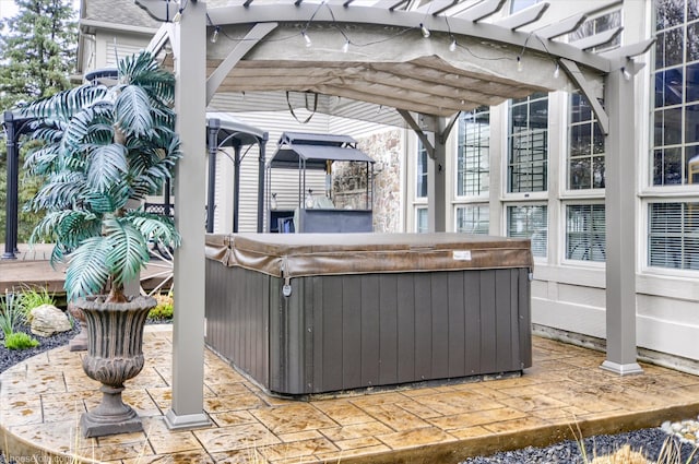 view of patio with a hot tub and a pergola