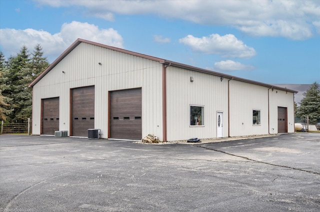 view of outbuilding with central air condition unit and an outdoor structure