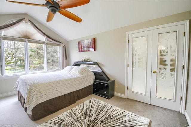 bedroom with light colored carpet, vaulted ceiling, baseboards, a ceiling fan, and french doors