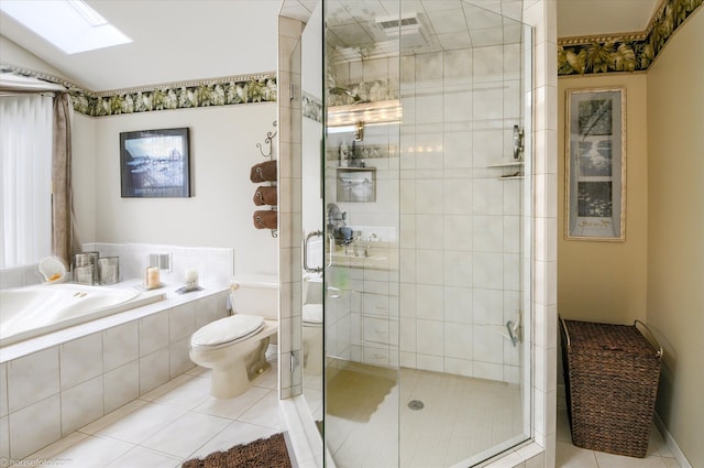 full bath featuring a bath, a shower stall, toilet, tile patterned flooring, and a skylight
