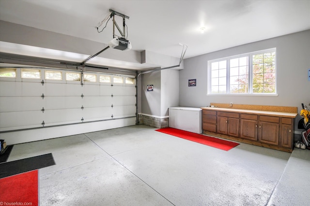 garage with a garage door opener and refrigerator