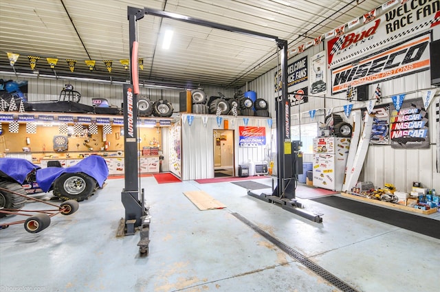 garage featuring a workshop area and metal wall