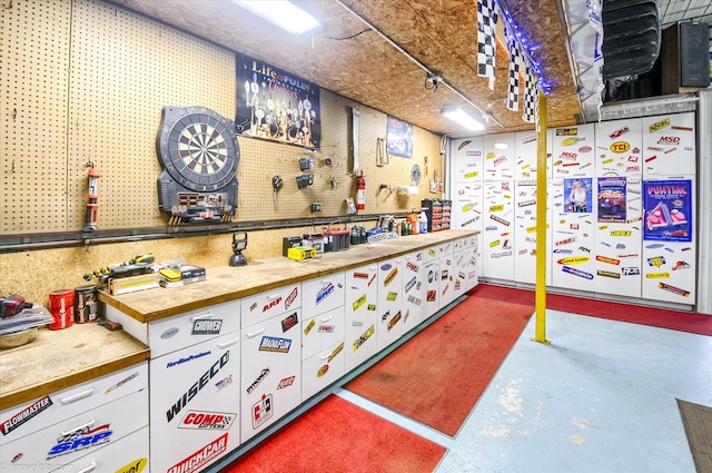 misc room featuring a workshop area and concrete floors