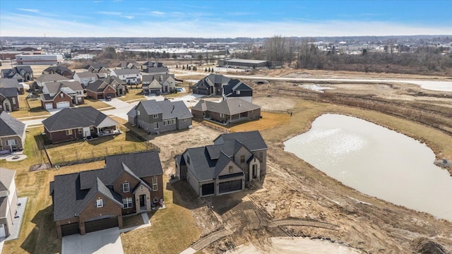aerial view of residential area featuring a large body of water