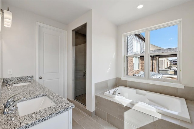 full bath with a stall shower, a bath, tile patterned flooring, recessed lighting, and double vanity
