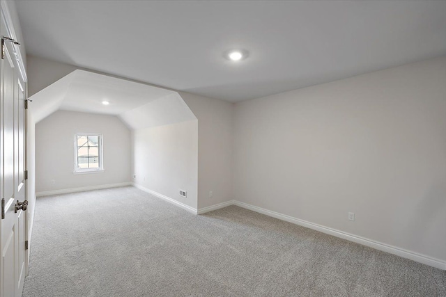 additional living space with carpet floors, baseboards, vaulted ceiling, and recessed lighting