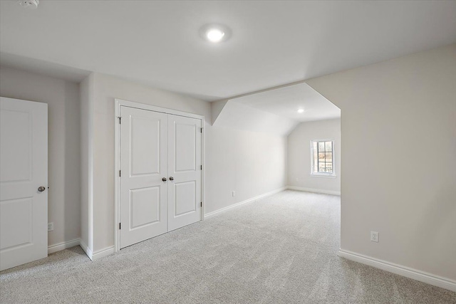 bonus room with carpet, baseboards, and vaulted ceiling
