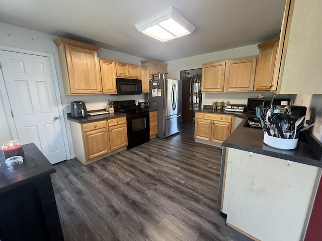 kitchen with black appliances, dark countertops, and dark wood-style flooring