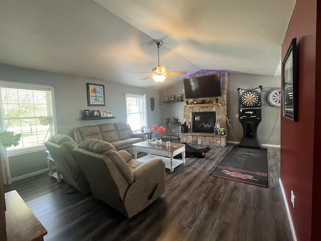 living room featuring baseboards, a fireplace, dark wood-style floors, vaulted ceiling, and a ceiling fan