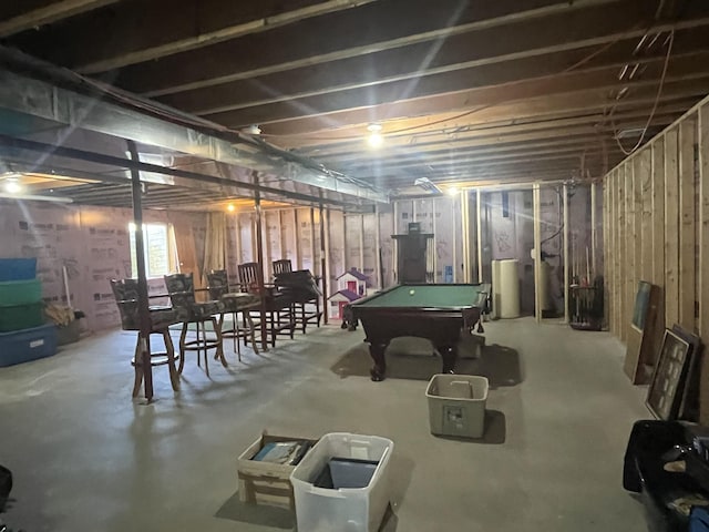 below grade area with billiards table and water heater