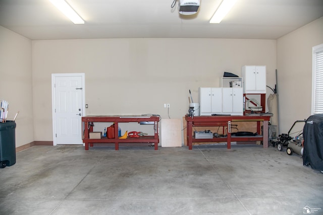 garage with a garage door opener and a workshop area