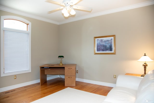 office with light wood finished floors, a ceiling fan, ornamental molding, and baseboards