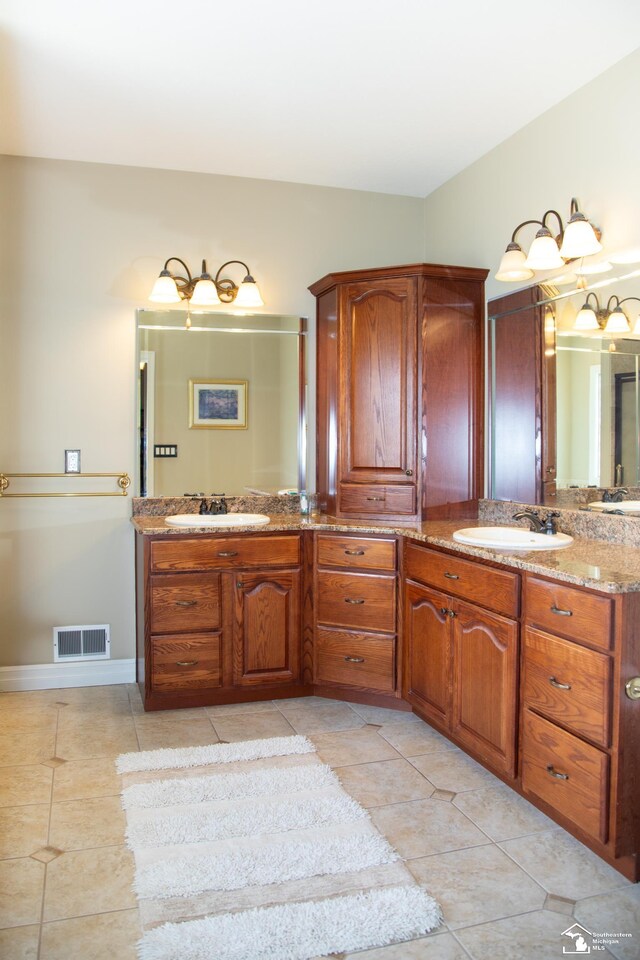 bathroom with tile patterned floors, vanity, and baseboards