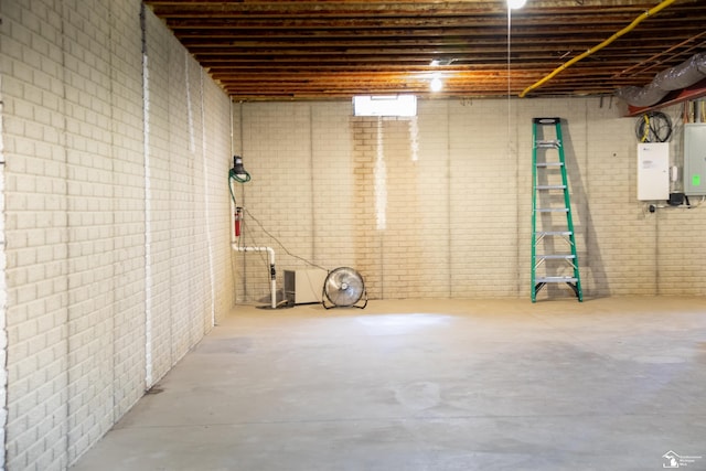 unfinished below grade area featuring brick wall and electric panel